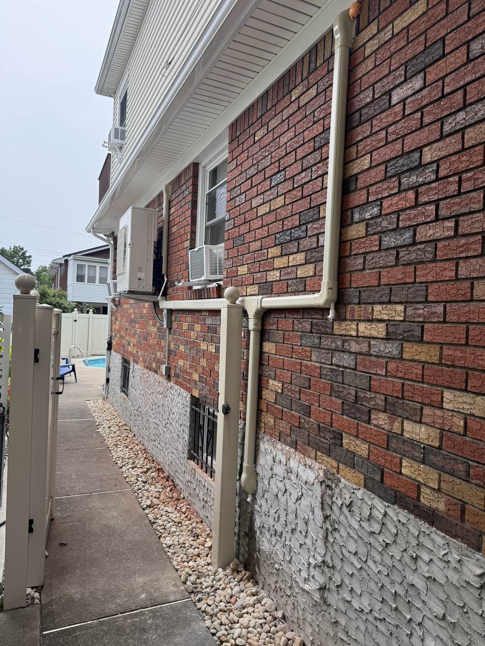 Clean exterior line-hide routing on a Brooklyn brick home